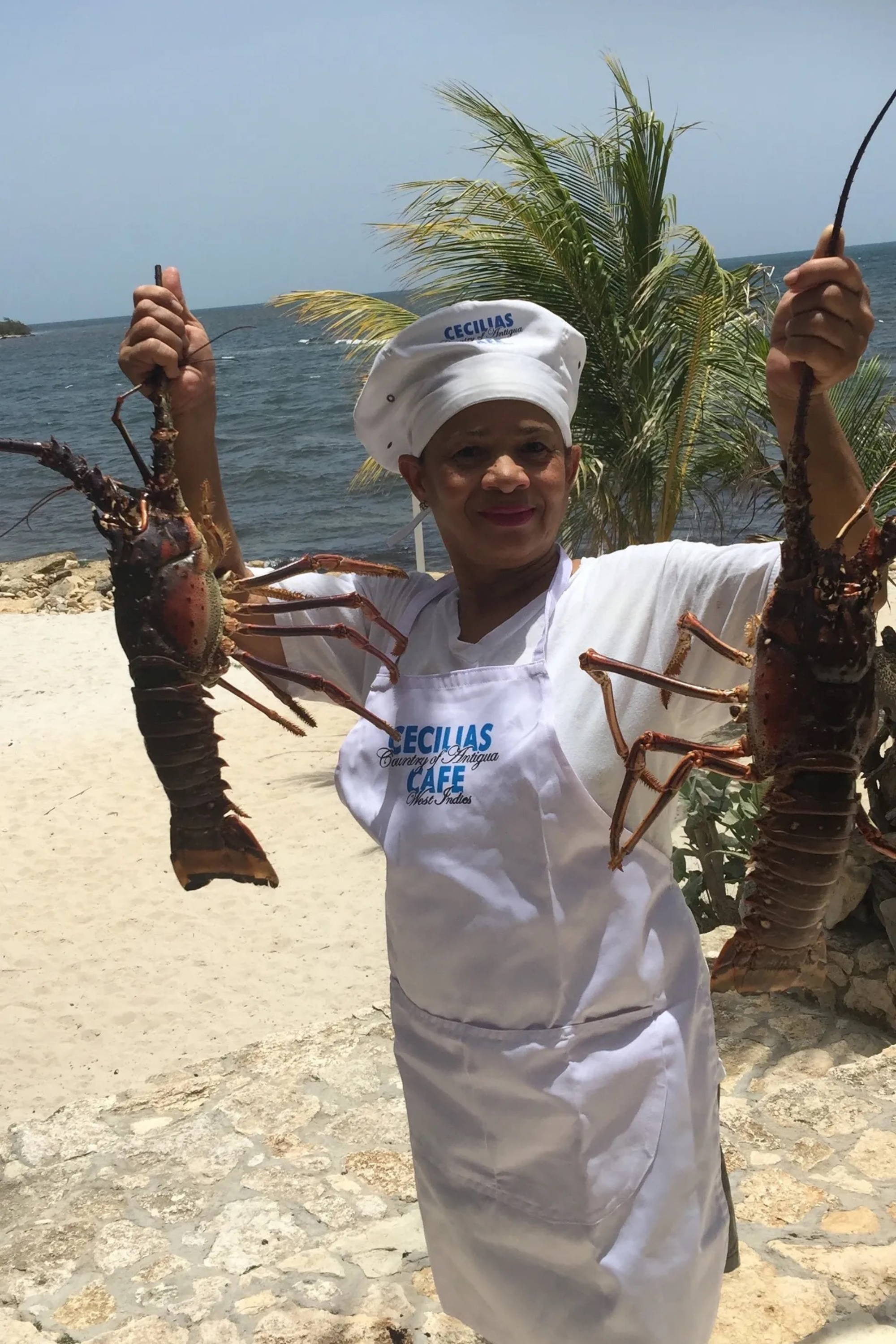 Chef holding lobsters at Cecilia's in Antigua in the Caribbean