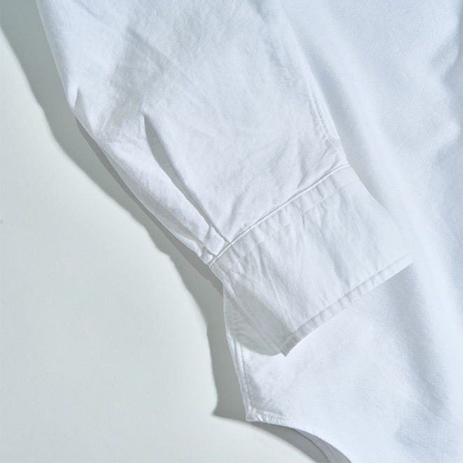 White shirt sleeve on a light background.