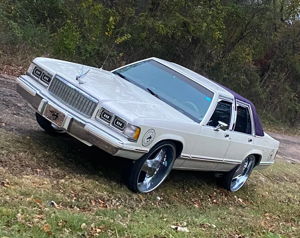White Mercury Grand Marquis with purple roof exterior view