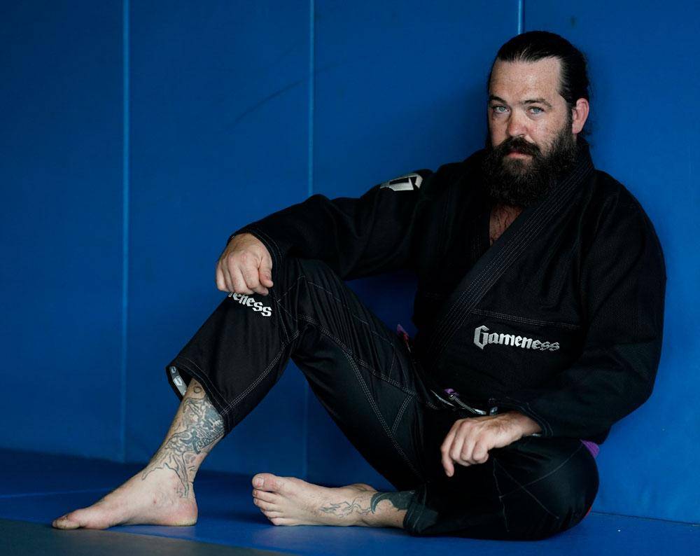 martial artist sitting on mat