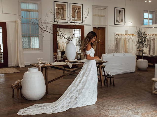 Rustic decor and whitewash floors inside Grace Loves Lace bridal shop