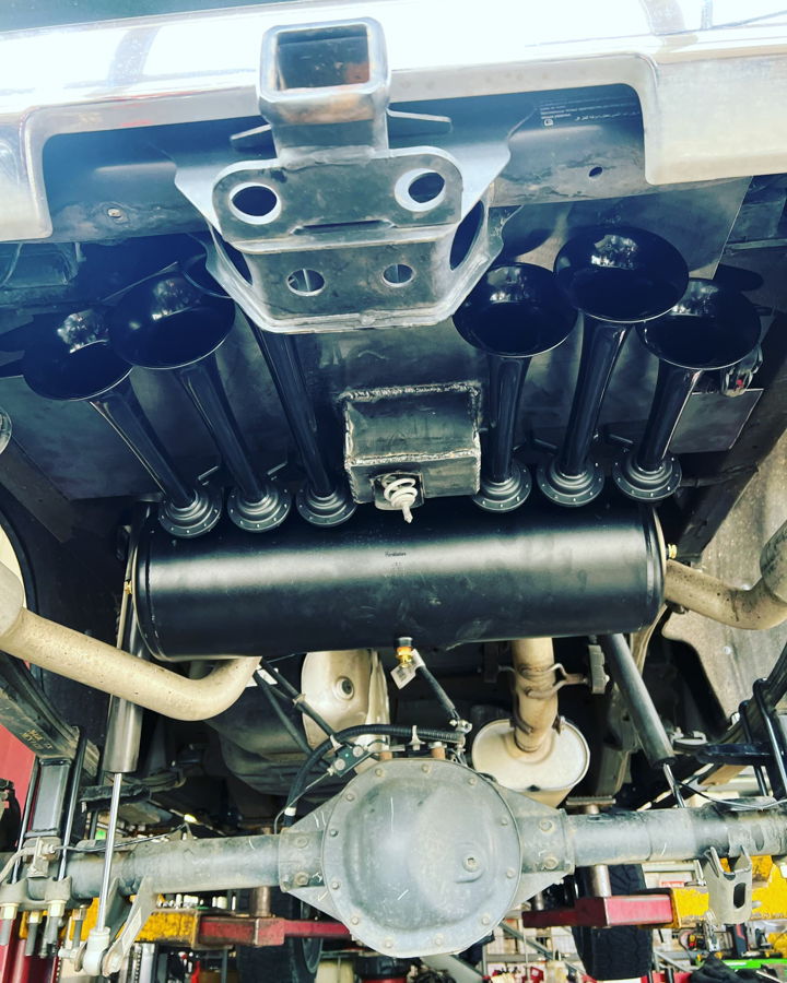 Rear undercarriage eight matte black Shocker XL horns and air tank Conductor's Special 844 Nightmare Edition spare tire delete Jimmy's 2020 Chevy Silverado 1500 gallery photo 2