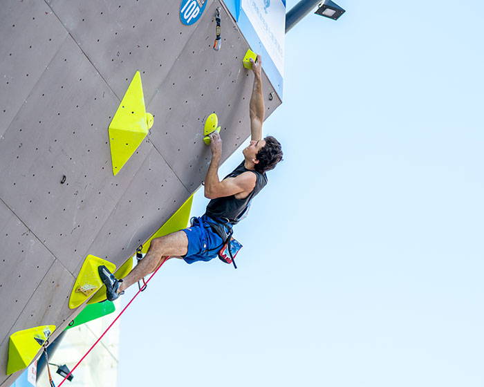 Jesse Grupper on climbing wall in the finals