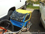 Blue yellow child bike trailer hitched red mountain bike white truck gravel driveway Will's 2011 Sweet Bicycle Shocker XL gallery photo 7