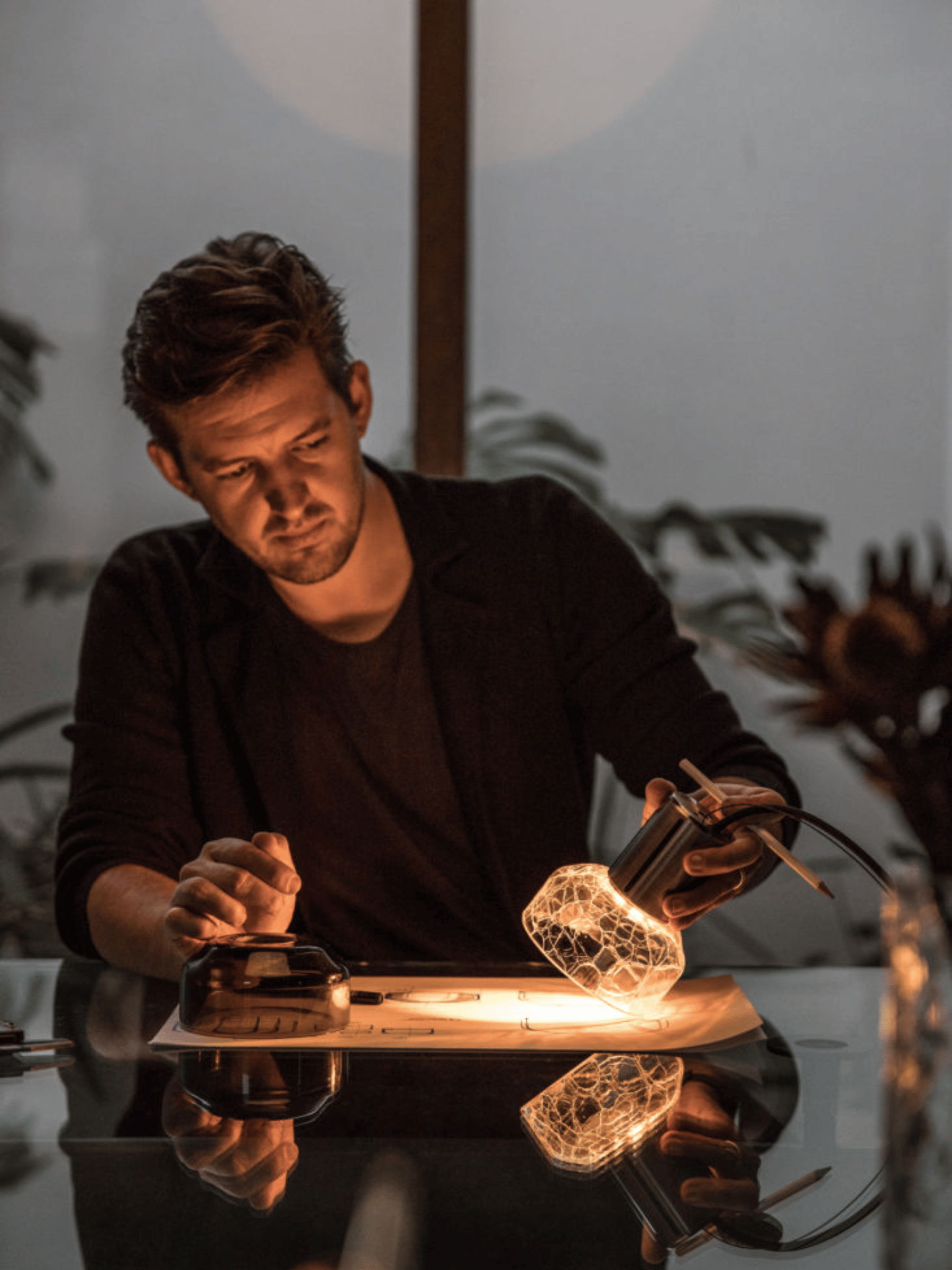Alex fitzpatrick holding crackle glass lighting pendant, soft glow