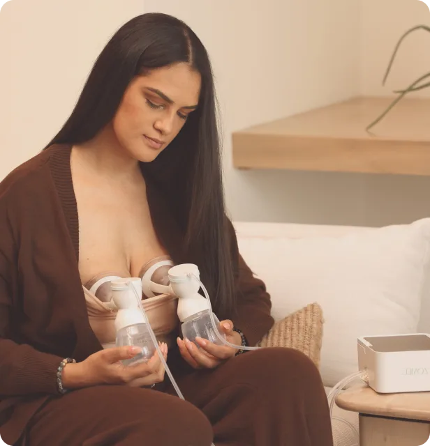 Mom using the Mother's Nature™ H1 Hospital-Grade, Dual Motor Breast Pump