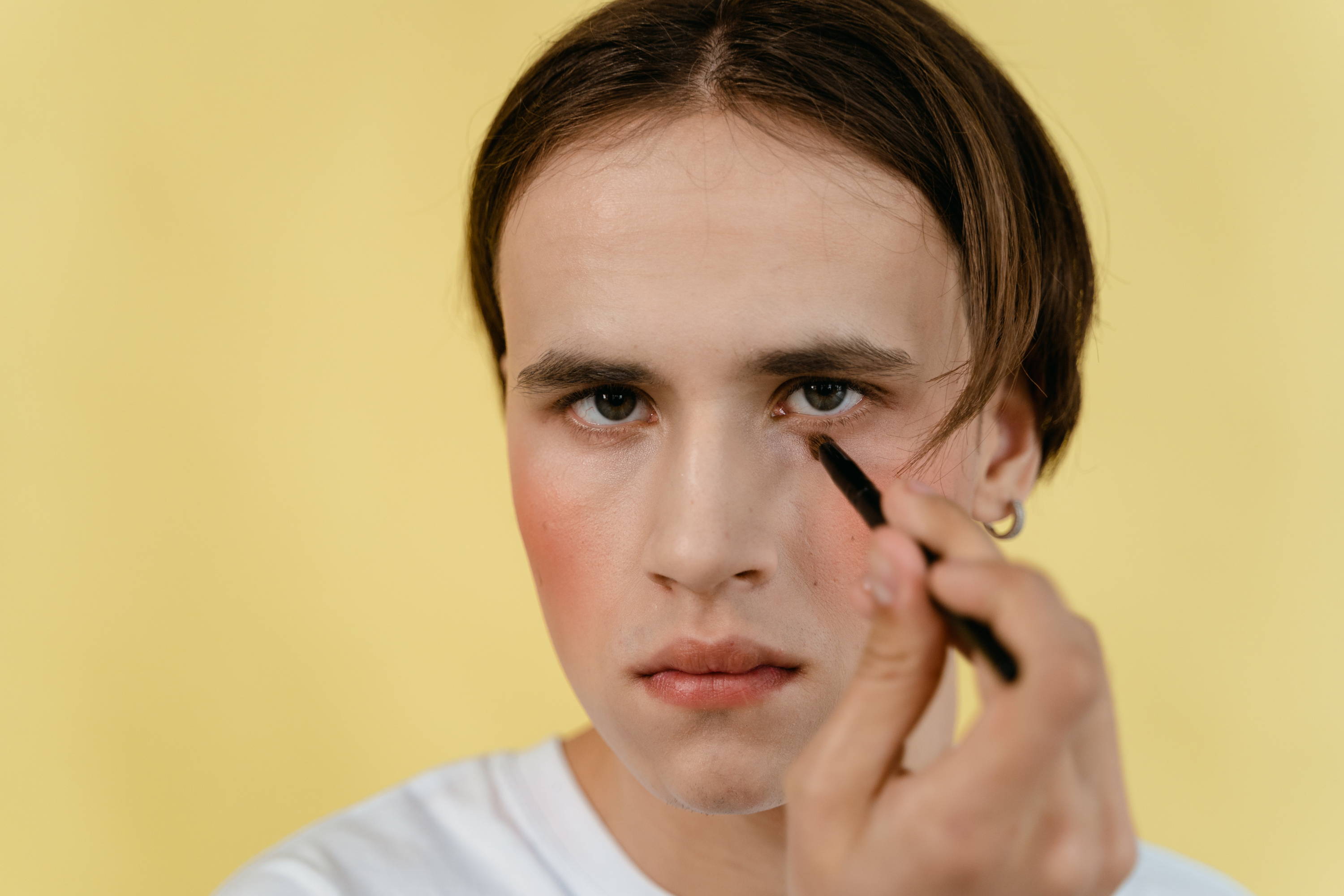 a man applying his own make up
