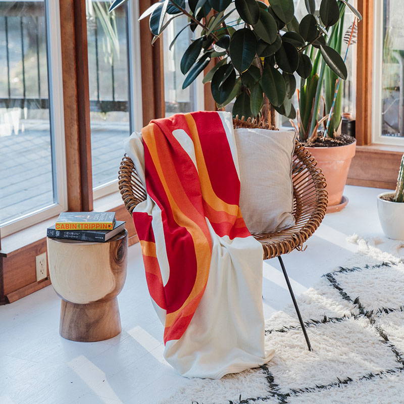 CozyHemp Blanket hanging off of chair
