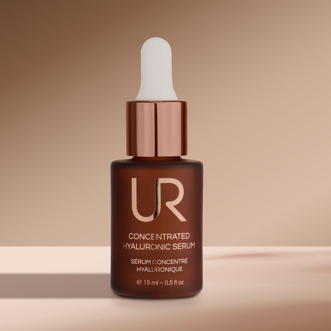 Brown bottle of hyaluronic serum with a dropper against a neutral background.