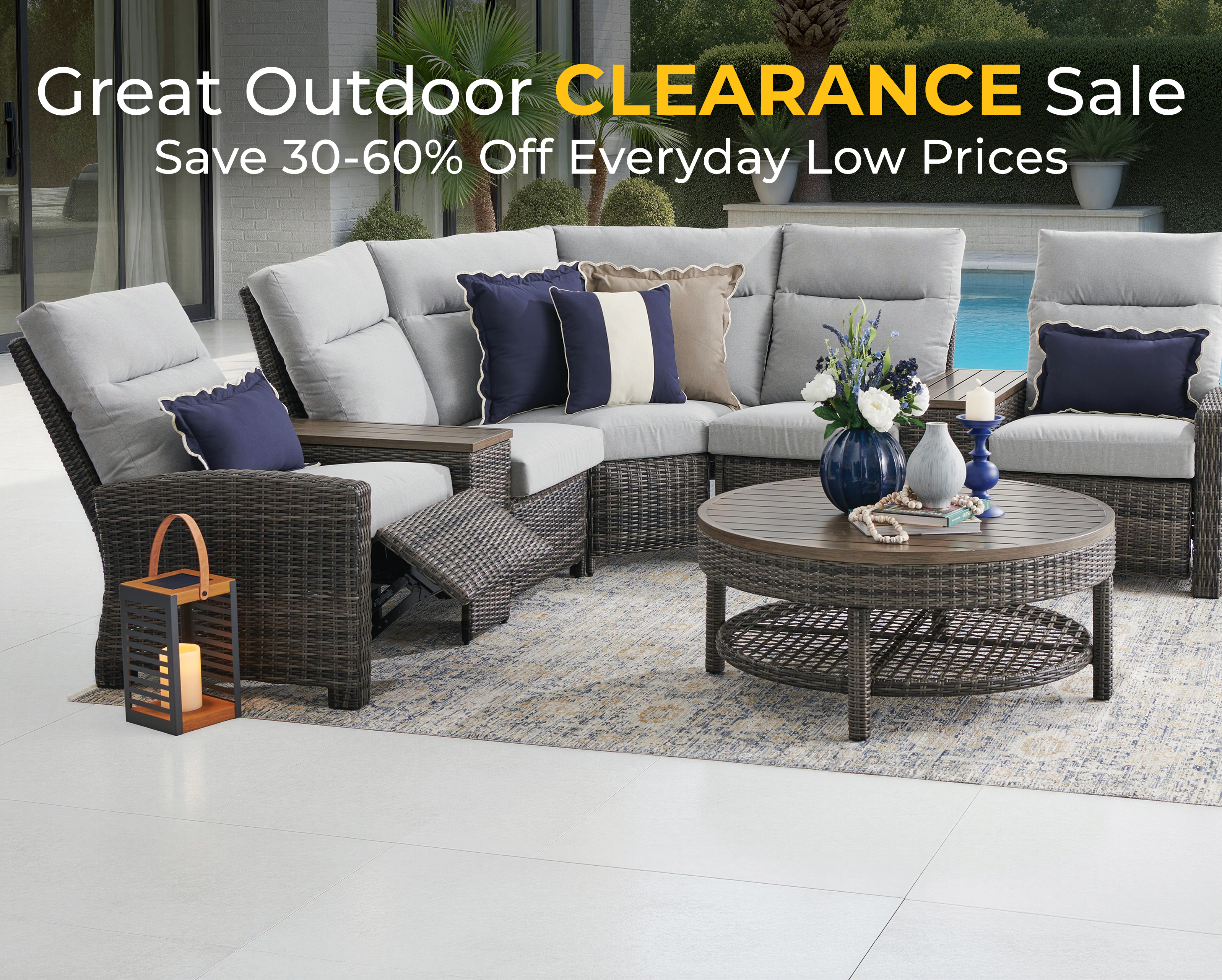 Outdoor furniture sale with seating, table, and decorative elements.