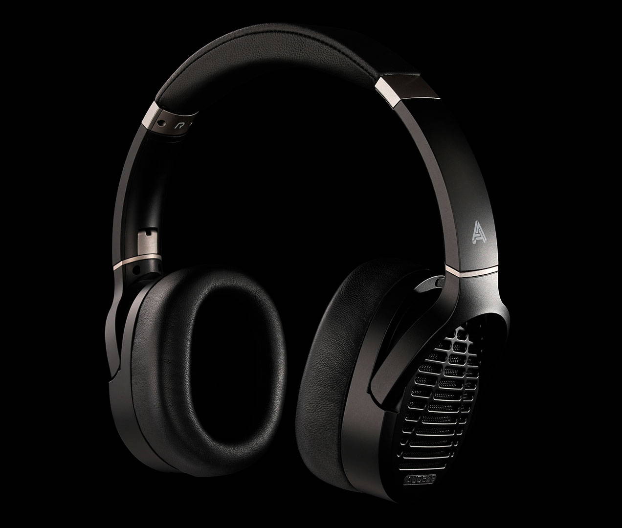 Black headphones resting against a dark background with soft ear cushions.