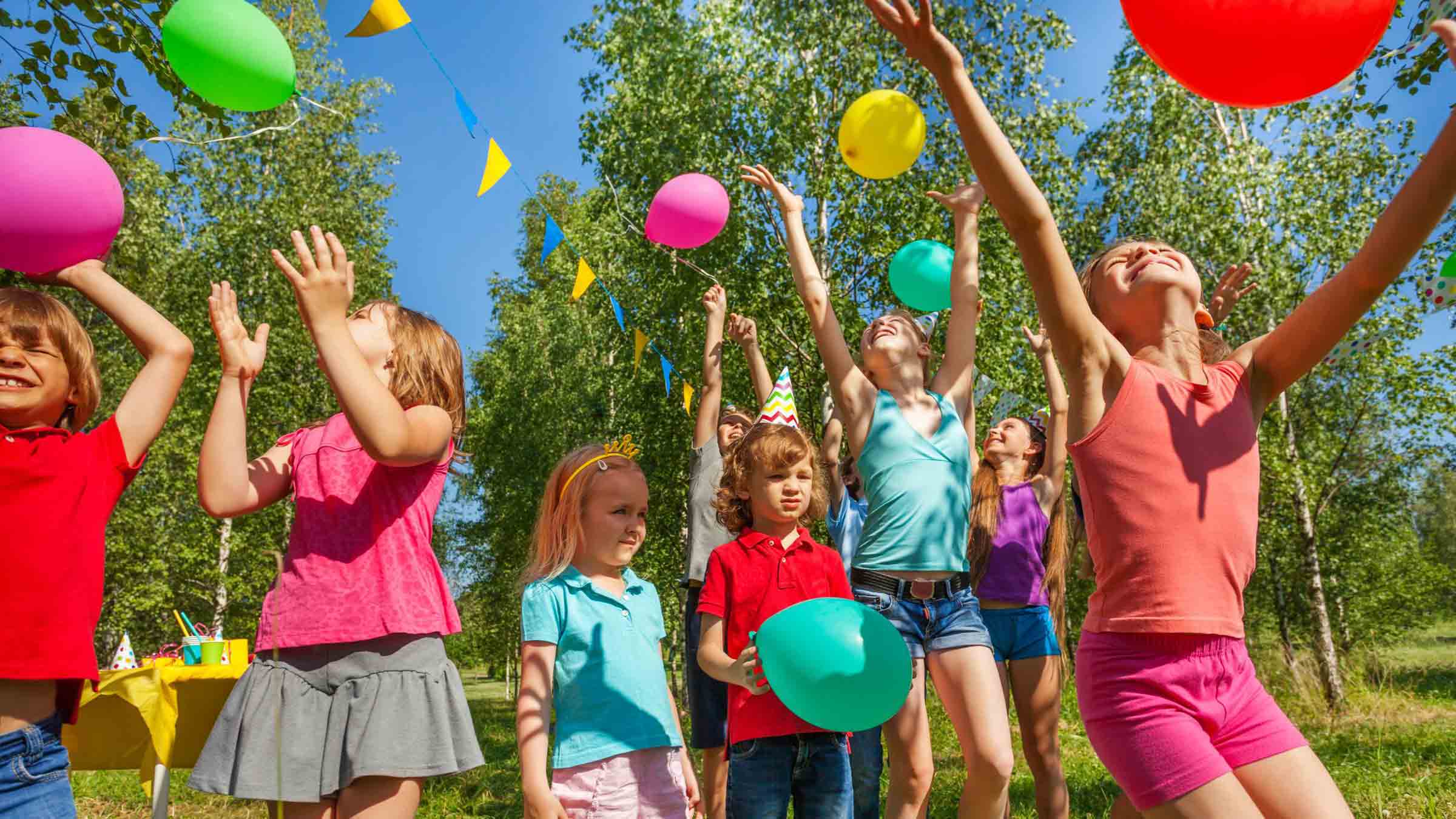 Children playing with balloons at the park