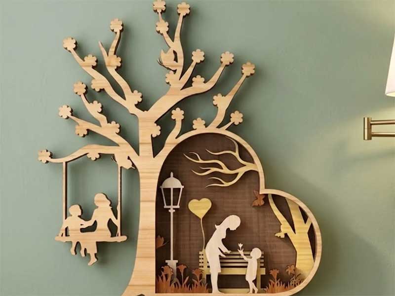 Wooden art piece depicting a tree, children, and a heart shape.