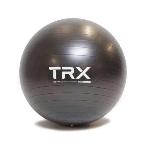 Woman exercising on a stability ball in a bright indoor space.