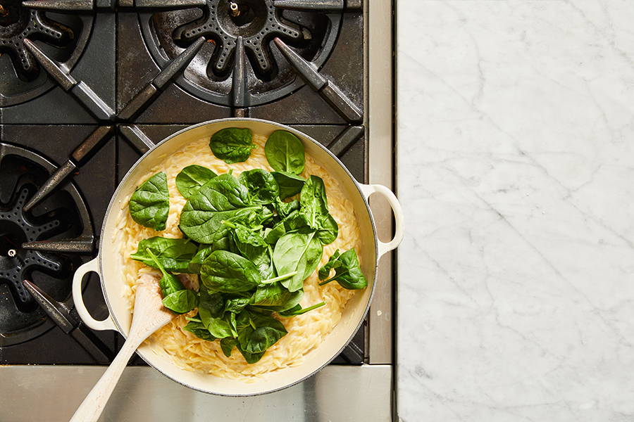 Spinach added to pan to cook