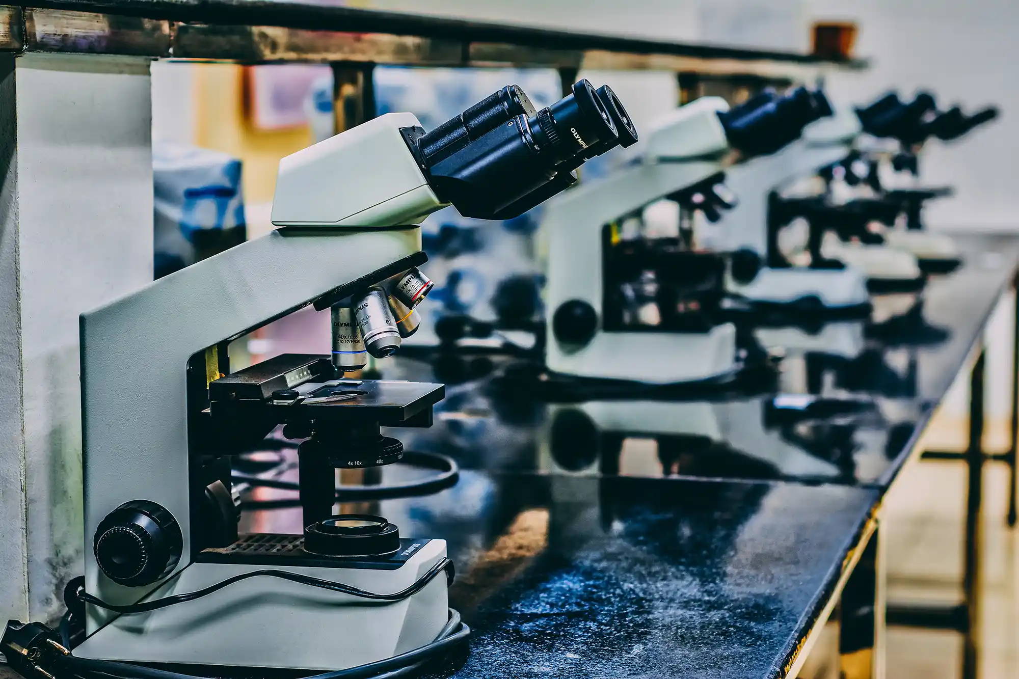 A row of microscopes on a table