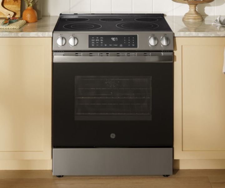 A modern black and stainless steel kitchen stove with digital controls.