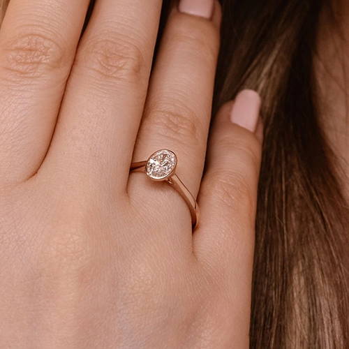 bezel set solitaire ring with an oval cut lab grown diamond center stone by MiaDonna