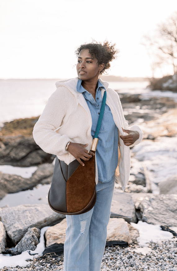 woman wearing brown leather crossbody bag