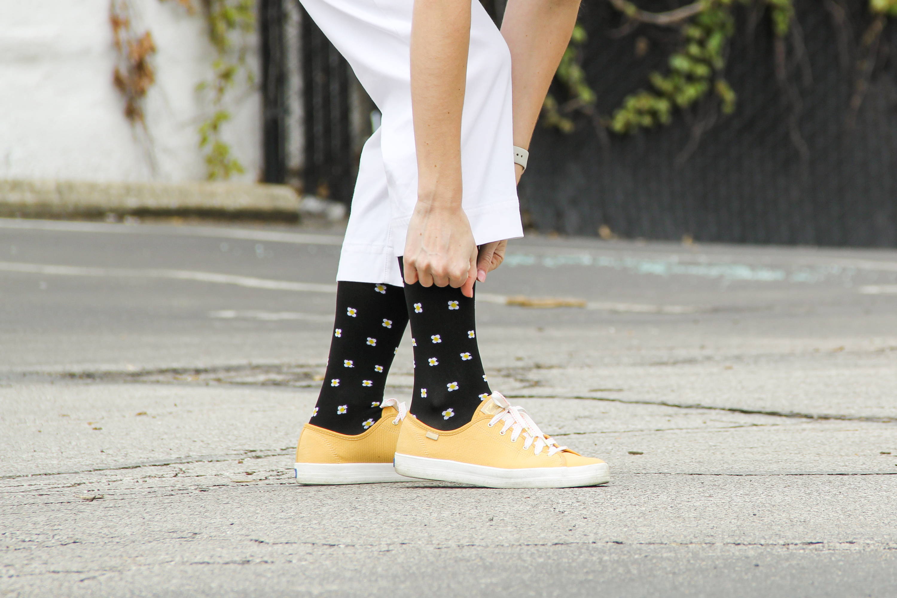 Woman pulling up Ease Gradient Socks while outdoors