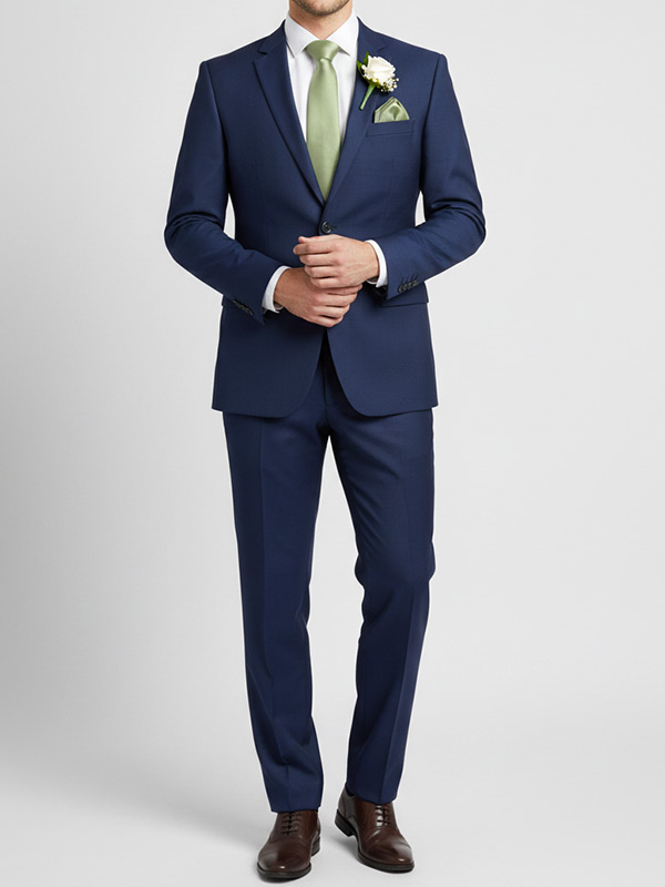 Groomsman wearing a sage tie with a a navy suit and brown dressshoes