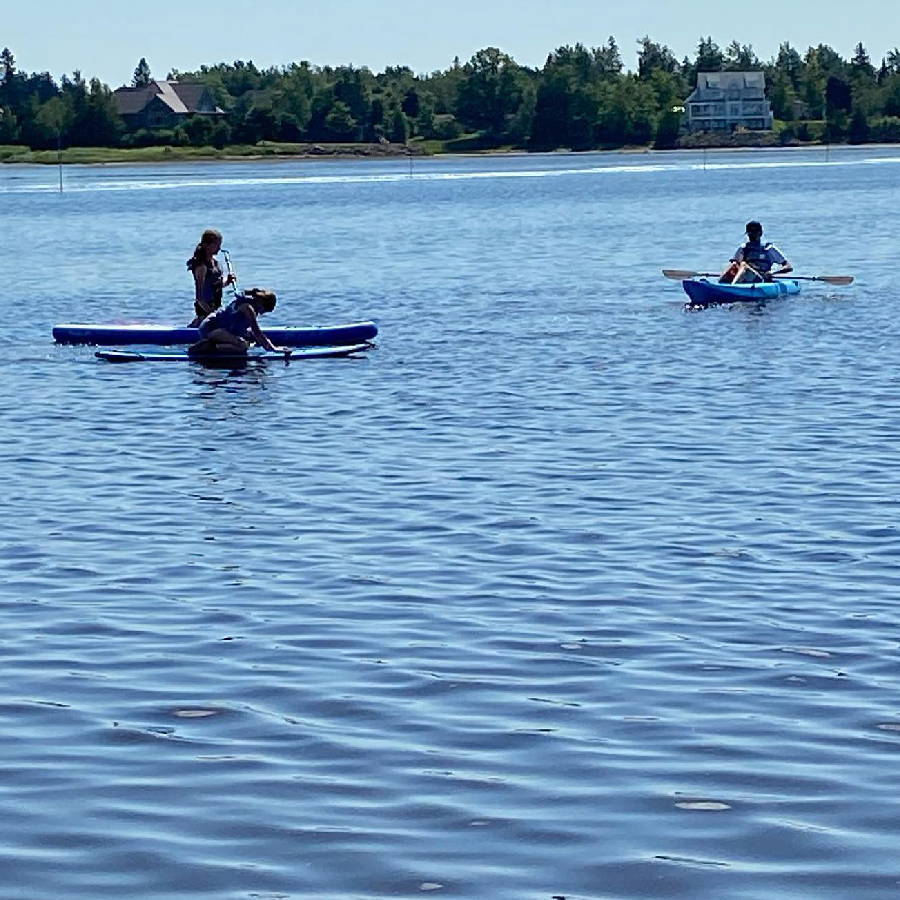people on kayaks in a lake