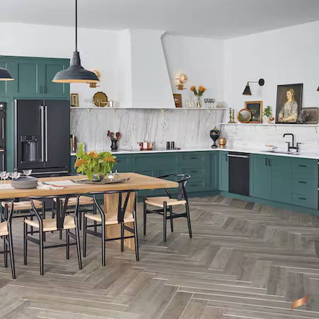 Matte black appliances in kitchen with sage green cabinets
