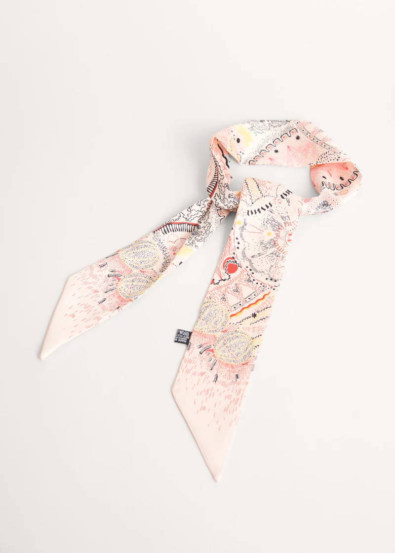 A pale pink satin neck scarf with a  colourful abstract patterns