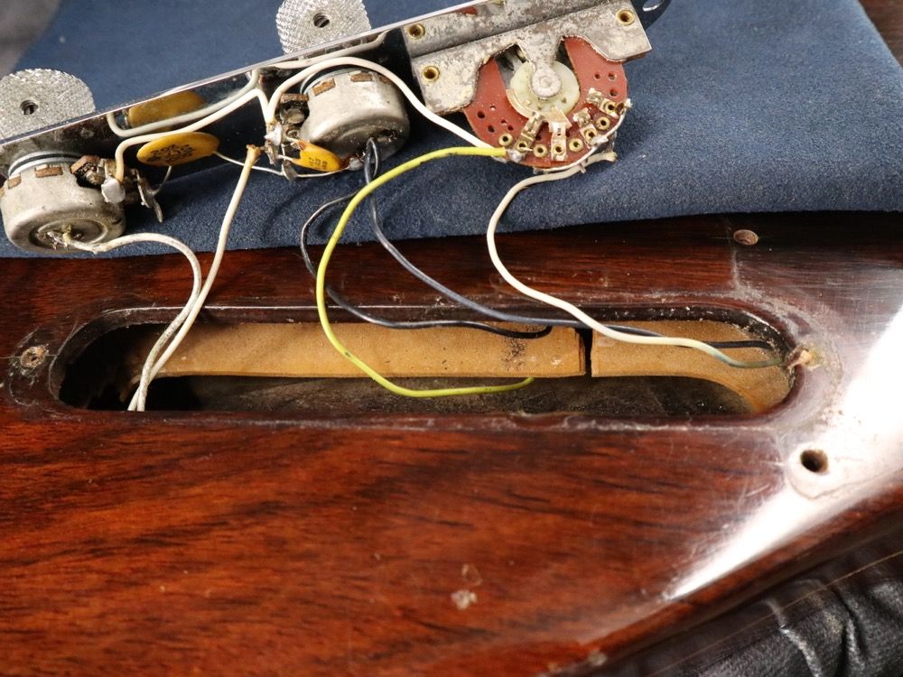 Close-up of guitar electronics and wiring inside the body.