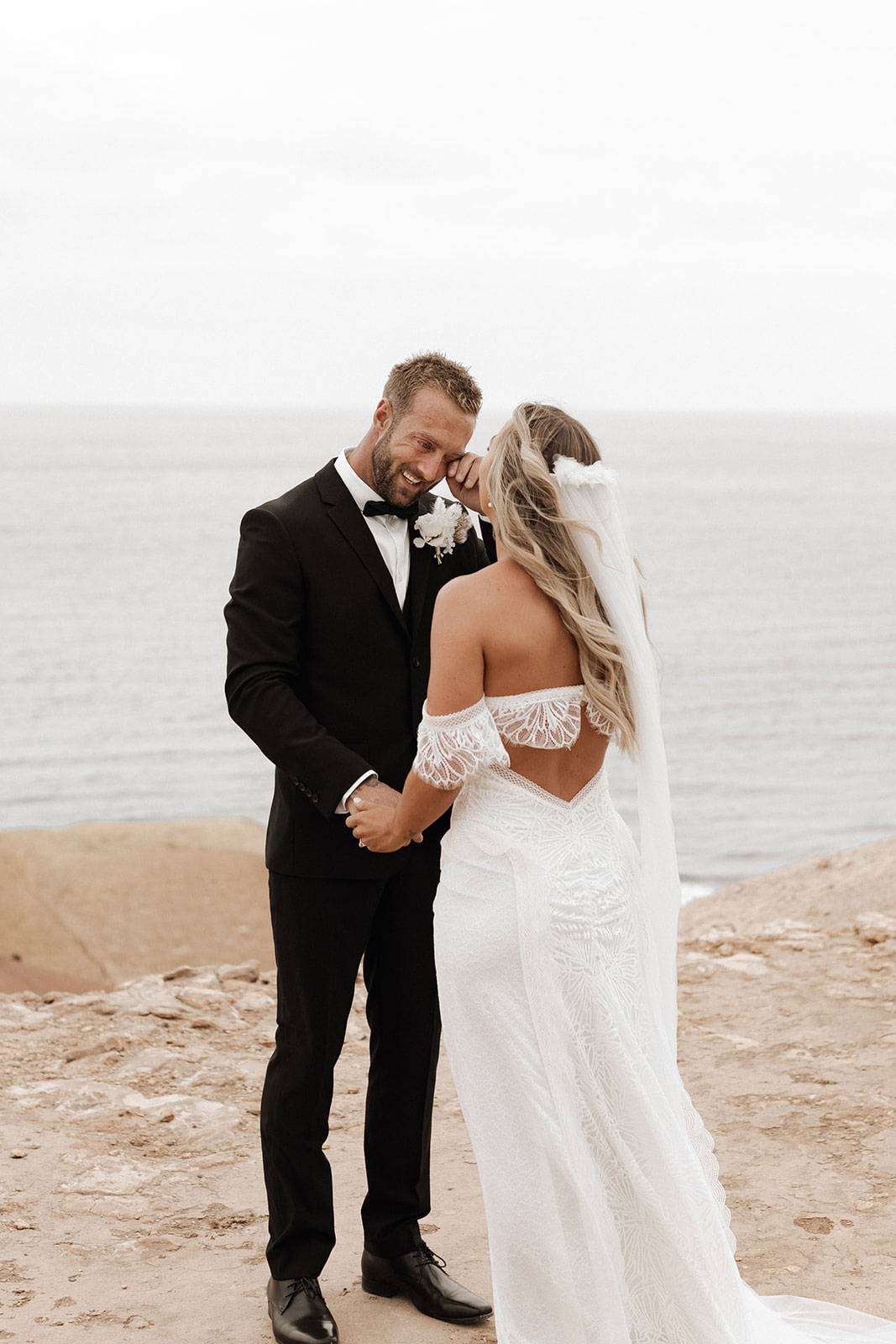 Bride and groom overlooking ocean