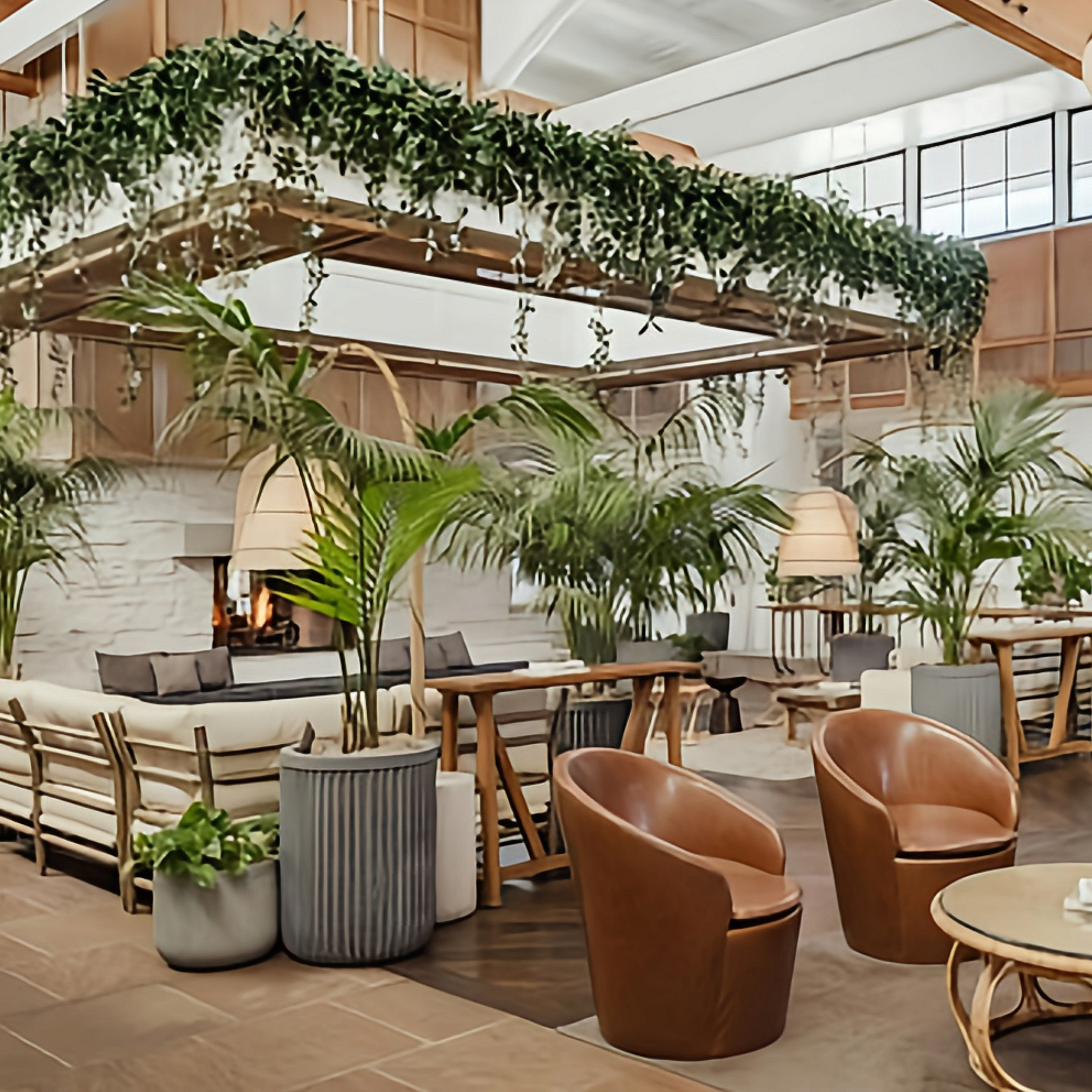 Modern lobby with greenery, comfortable seating, and natural light.