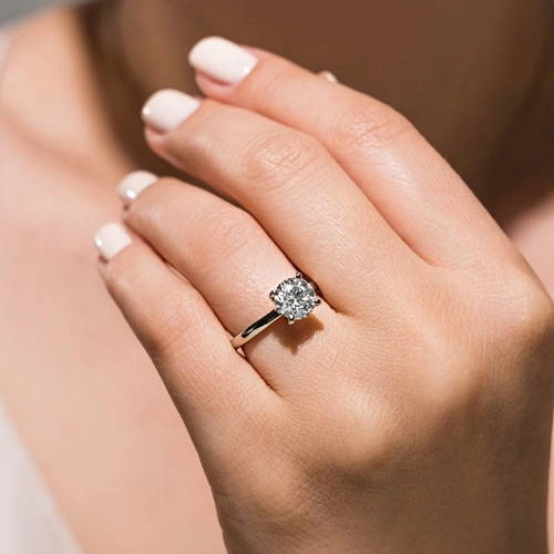 Woman wearing a traditional solitaire engagement ring with a lab grown diamond by MiaDonna