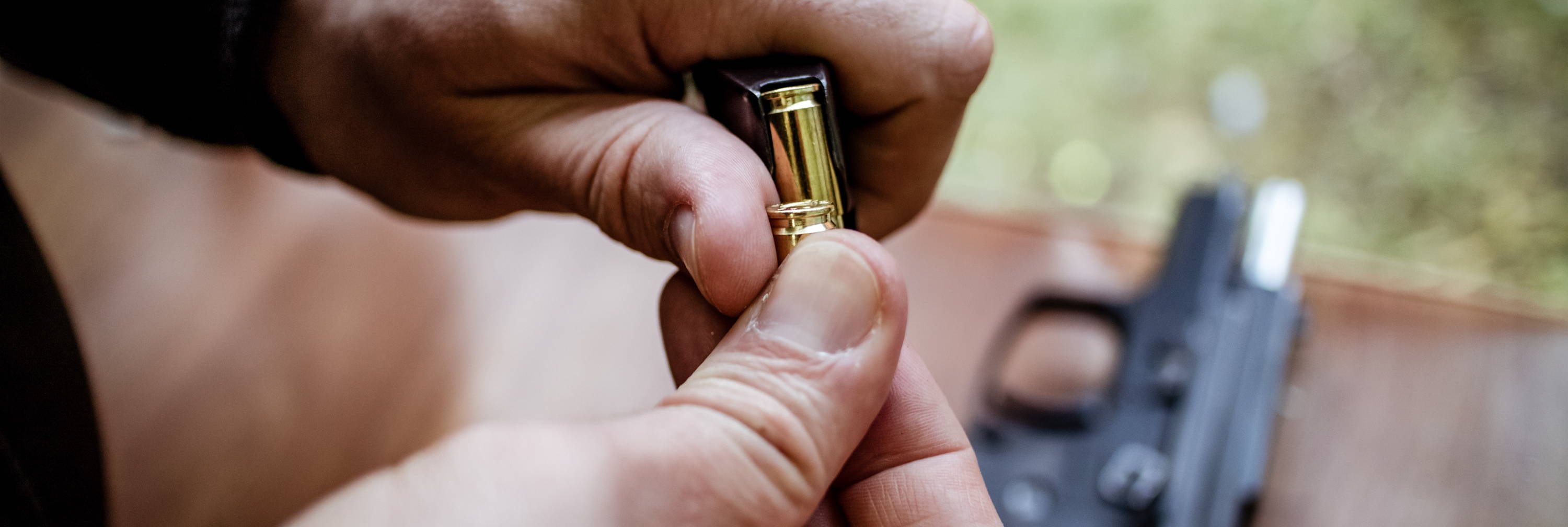 Man loading firearm at shooting range