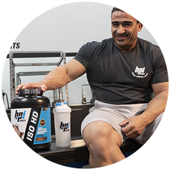 Picture of Kamal Elgarni with a bottle of Iso HD™ Sitting on a bench in the gym.