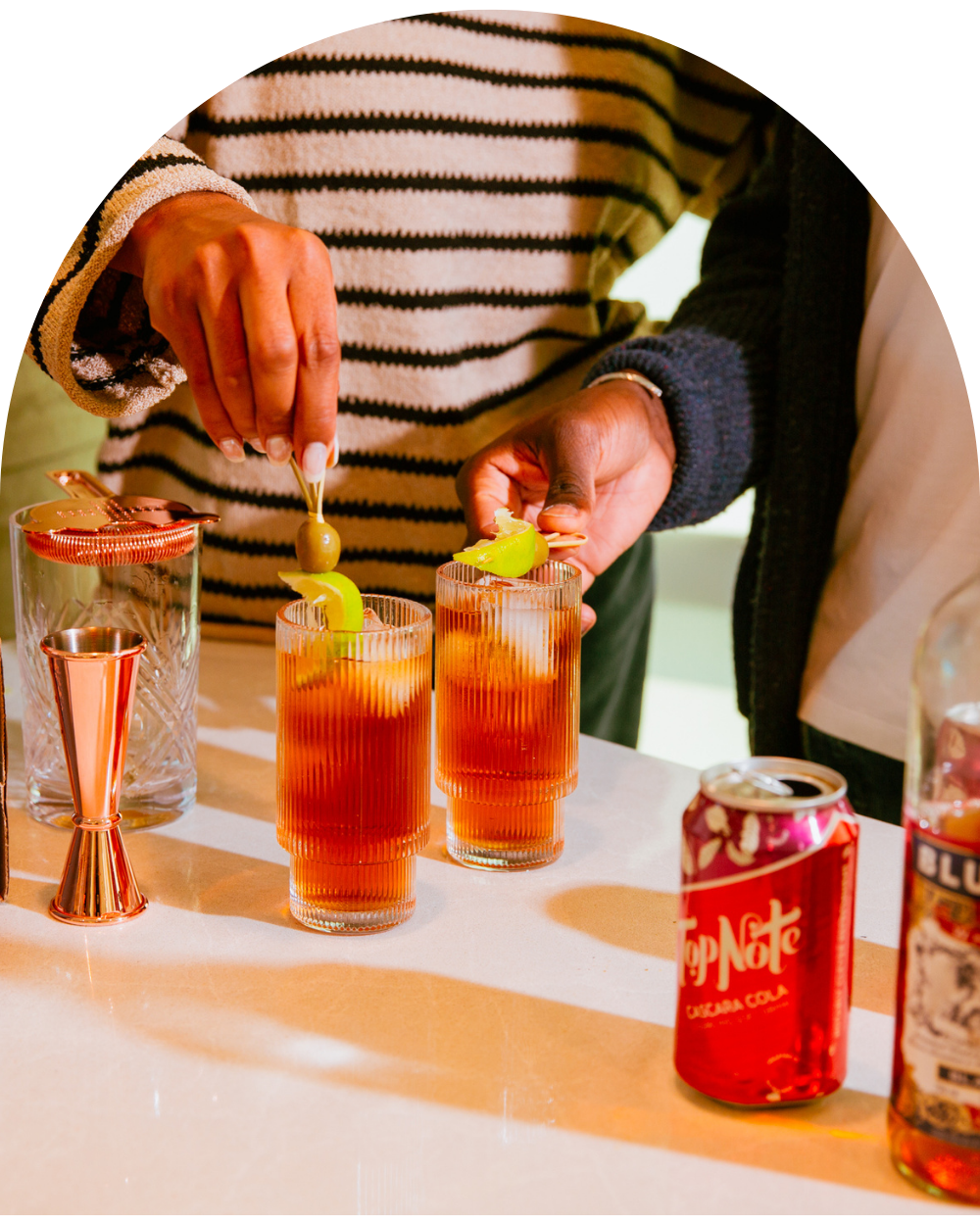 Two people garnishing cocktails