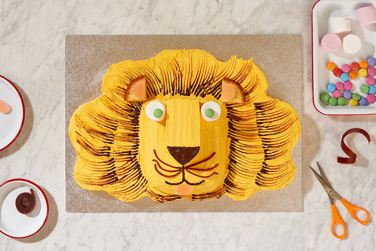 A photograph of a lion shaped cake fully decorated and baked using Falcon Enamelware bakeware.