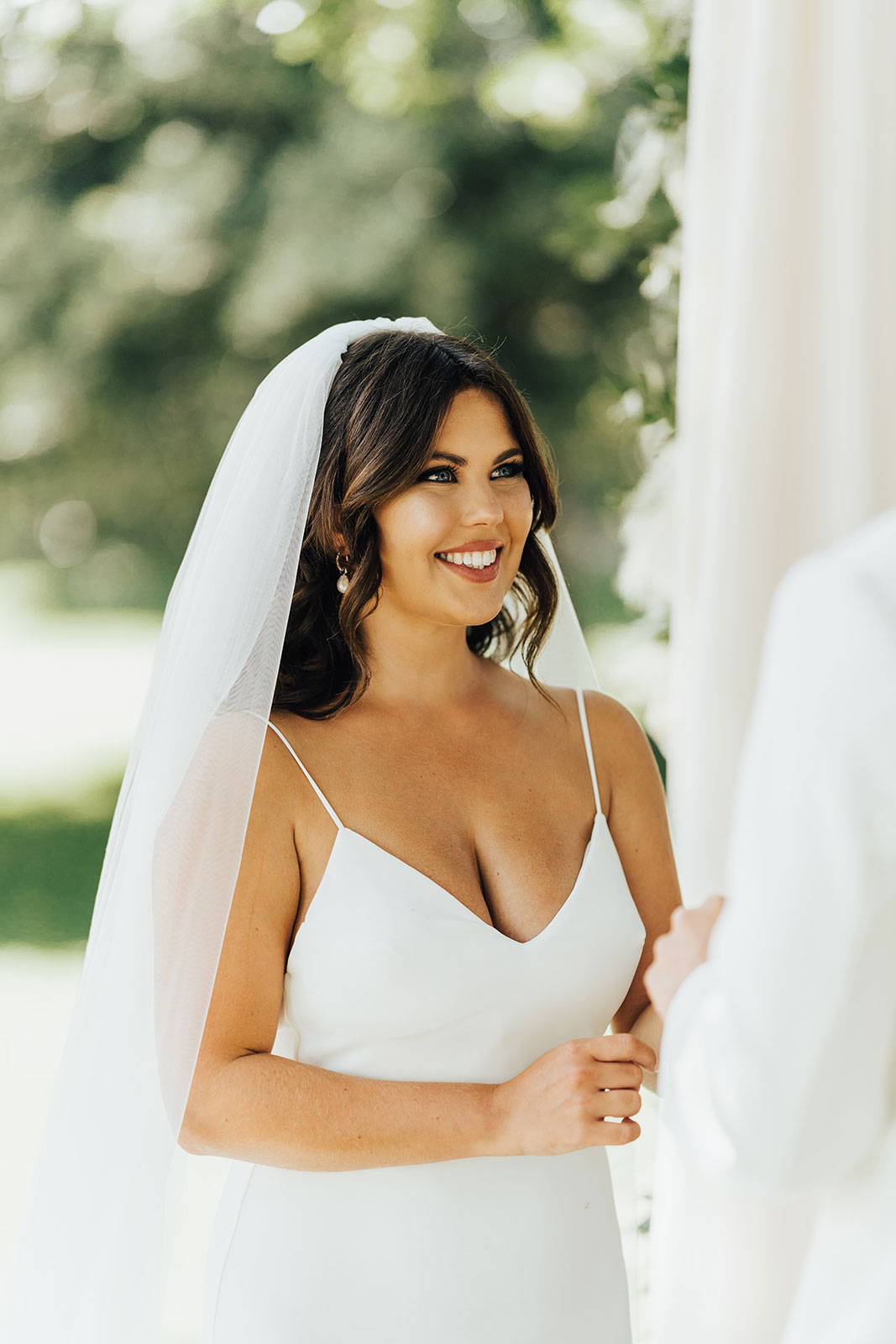 Bride smiling in her Henri Veil and Clo Pearl Gown