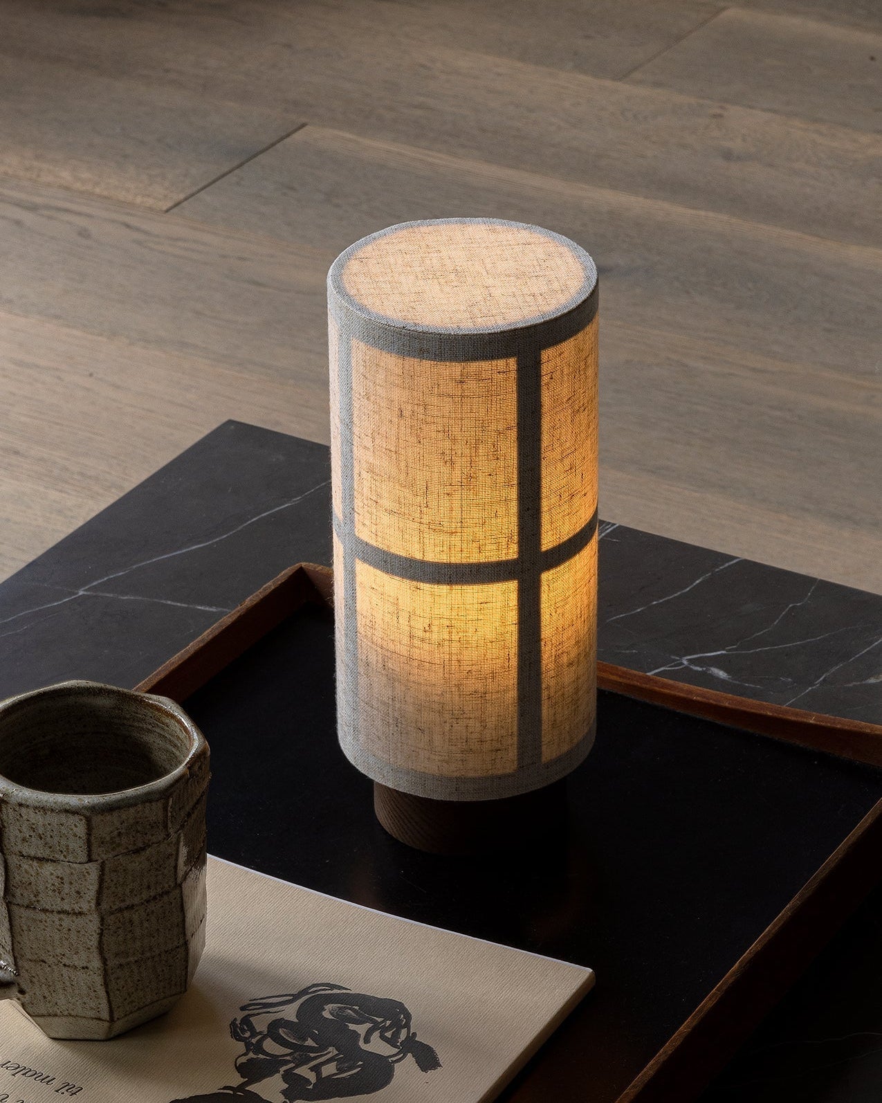 Hashira Table Lamp Portable on a minimalist surface