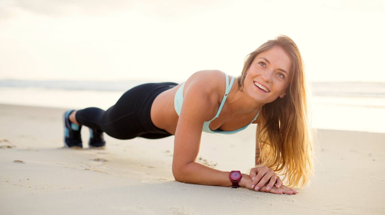 Woman planking at the beach | Best Ways to Lose Weight and Tone Up as a Vegetarian or Vegan | Featured