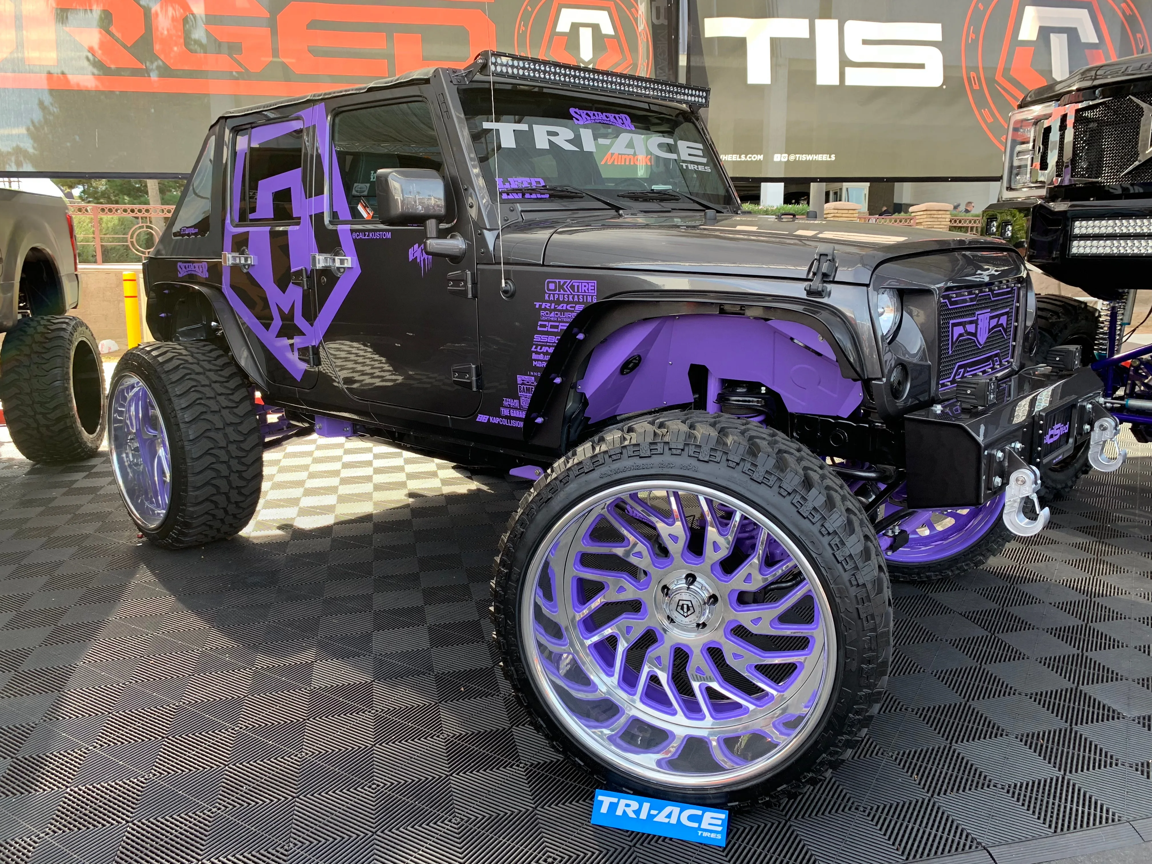 Front-three-quarter Janessa's 2017 Jeep Wrangler seven-slot grille round headlights chrome bumper exterior PsychoBlasters chrome air horn featured install photo 1