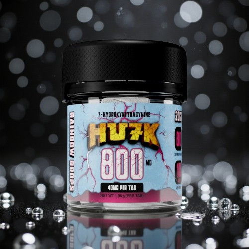 Container of HU7K 800, surrounded by sparkling elements on a dark background.