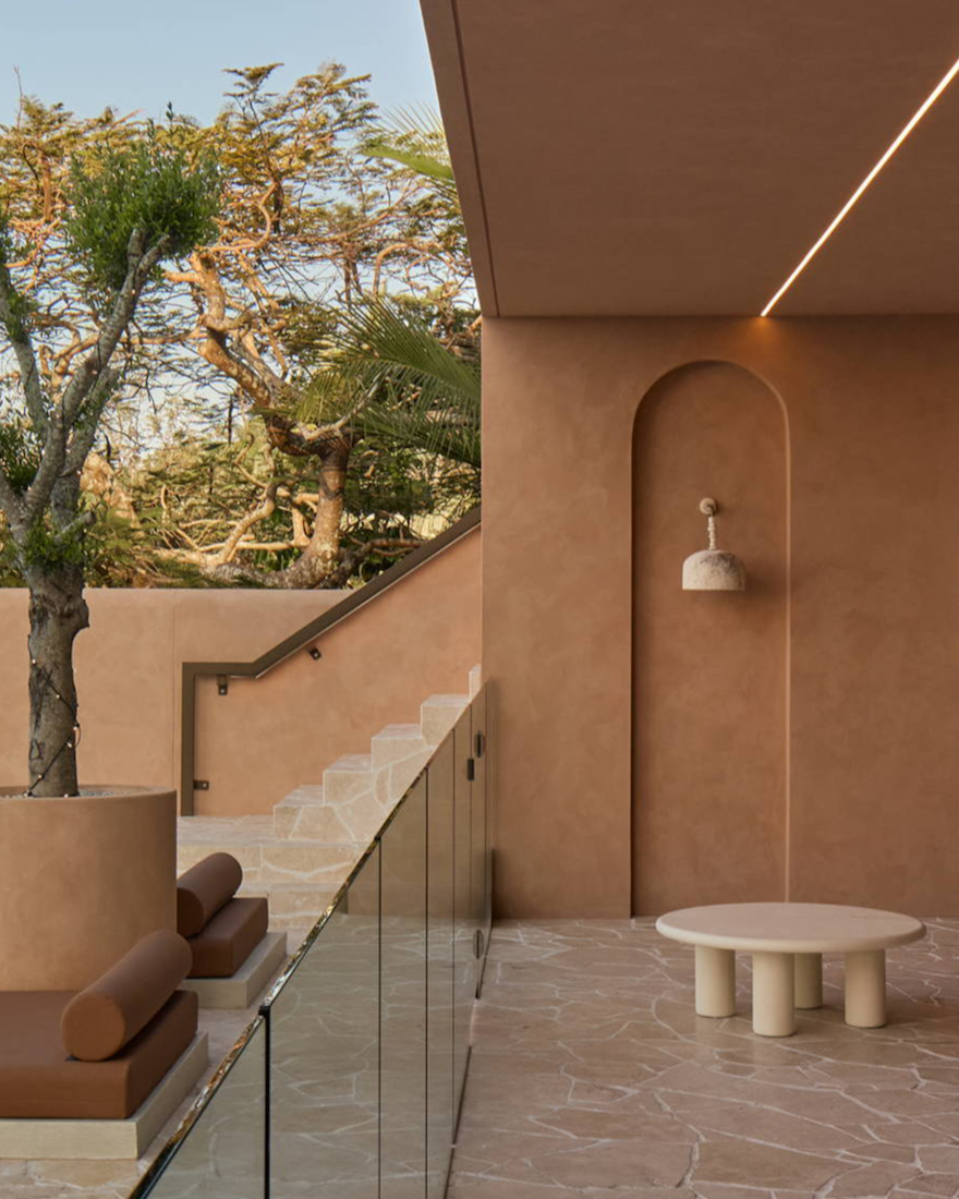 Modern outdoor space with minimalist furniture and greenery.