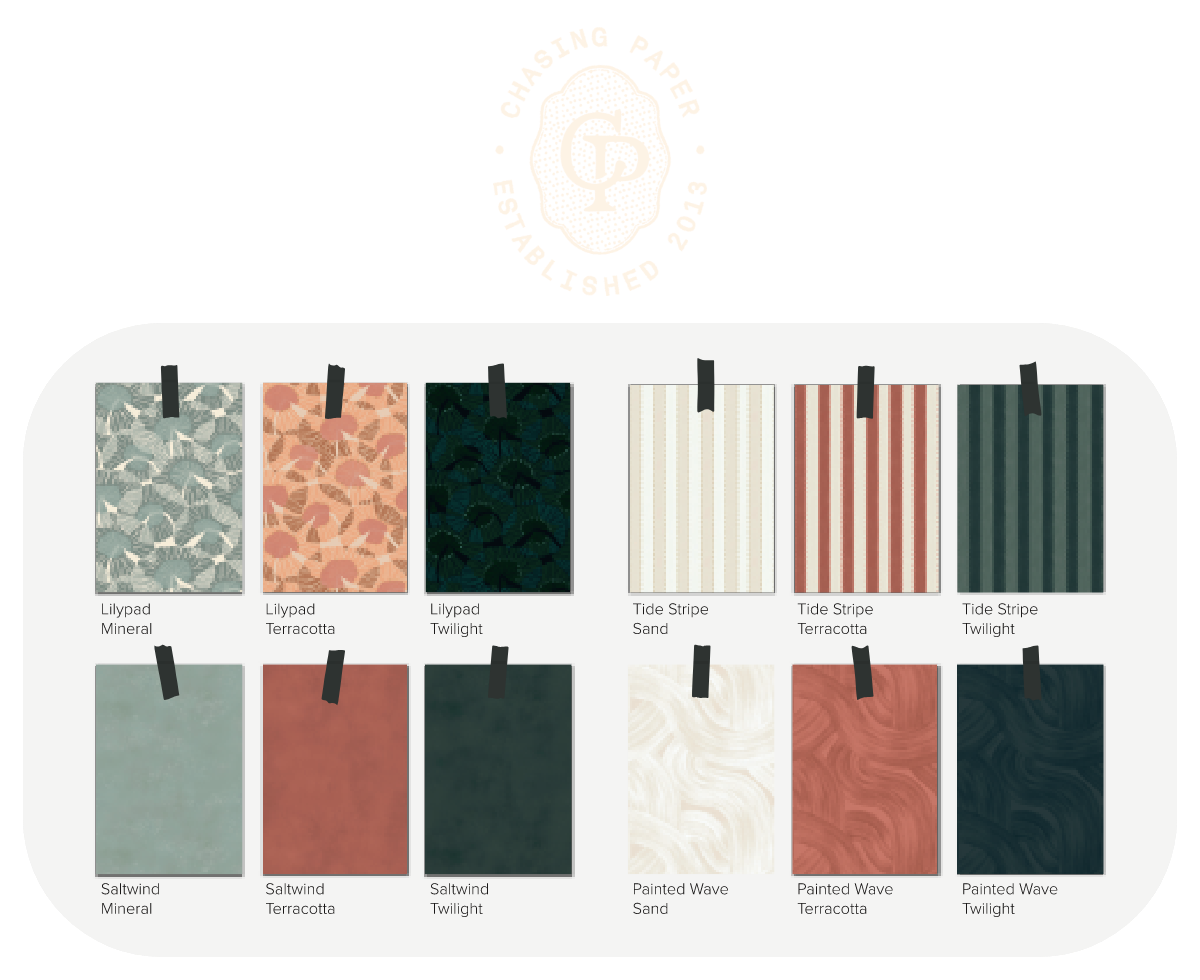 Collection of Chasing Paper wallpaper swatches displayed on clips.