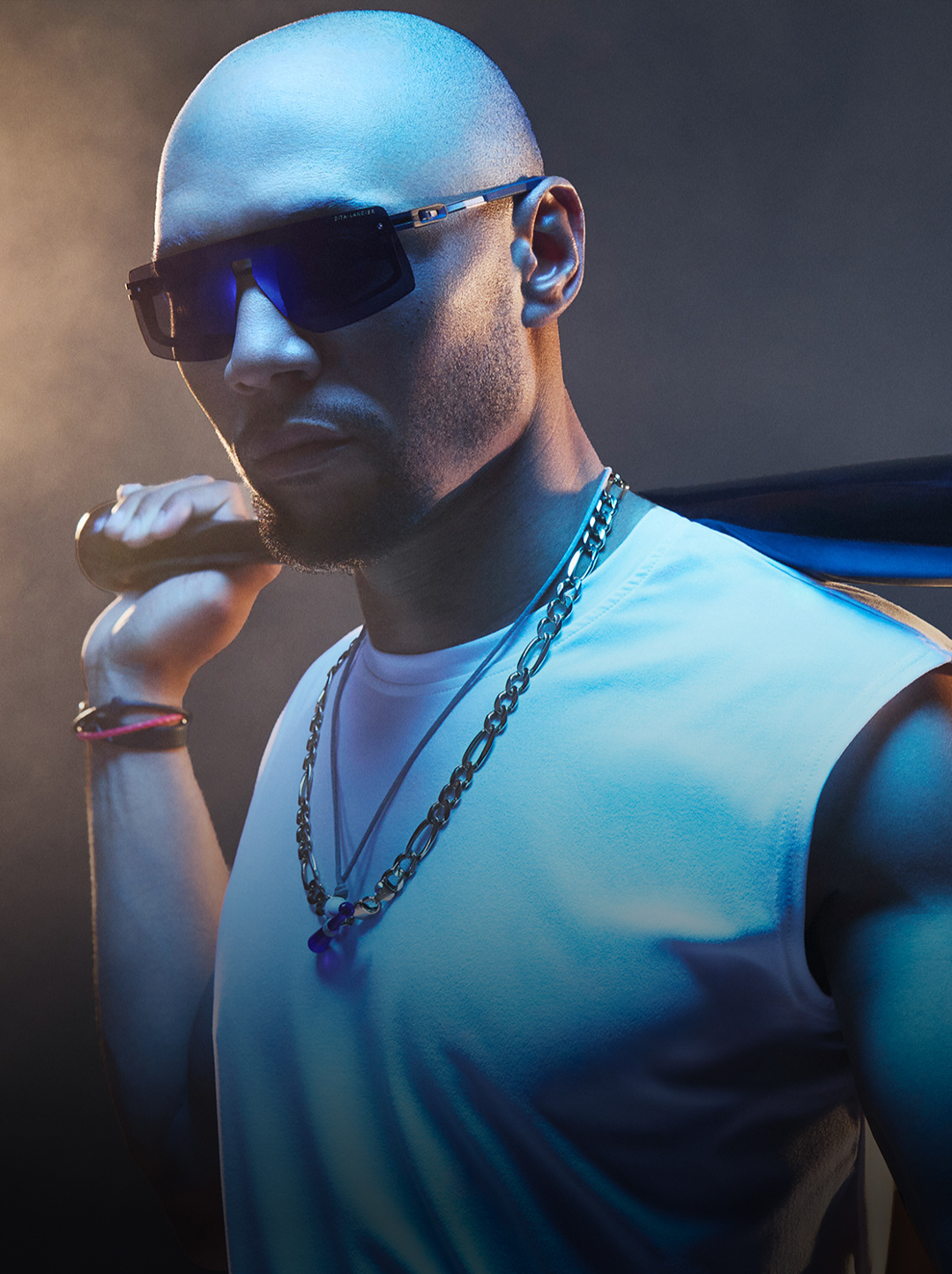 Mookie Betts in sunglasses with a baseball bat, wearing a sleeveless shirt and chains.