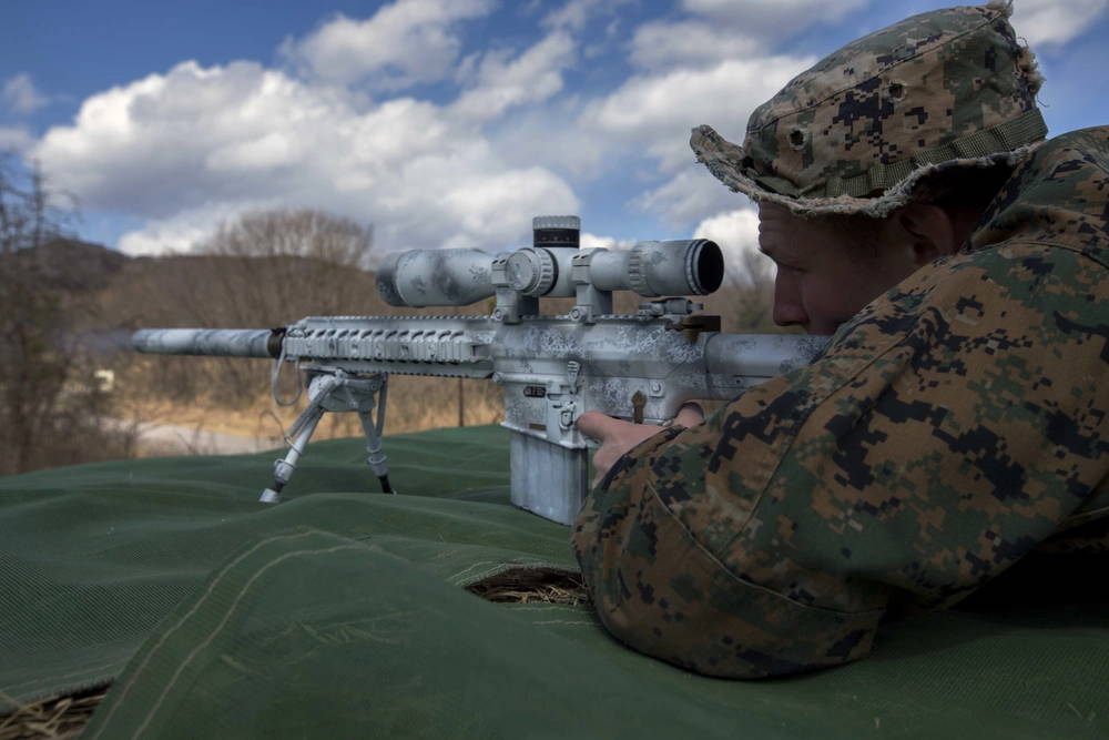 U.S. Marine Corps Lance Cpl. William Pearn, a Shohola, Pennsylvania native, fires at a target during exercise Forest Light at Somagahara, Japan, March 8, 2017. Forest Light is one of various bilateral training opportunities conducted by Japanese Ground Self Defense and forward deployed U.S. Marine Corps forces to demonstrate the enduring commitment by both countries to peace, stability, and prosperity across the region. Pearn is a machine gunner in training for scout sniper school and is attached to Golf Company, 2nd Battalion, 3rd Marine Regiment, which supports III Marine Expeditionary Force. (U.S. Marine Corps photo by MCIPAC Combat Camera Lance Cpl. Juan C. Bustos)