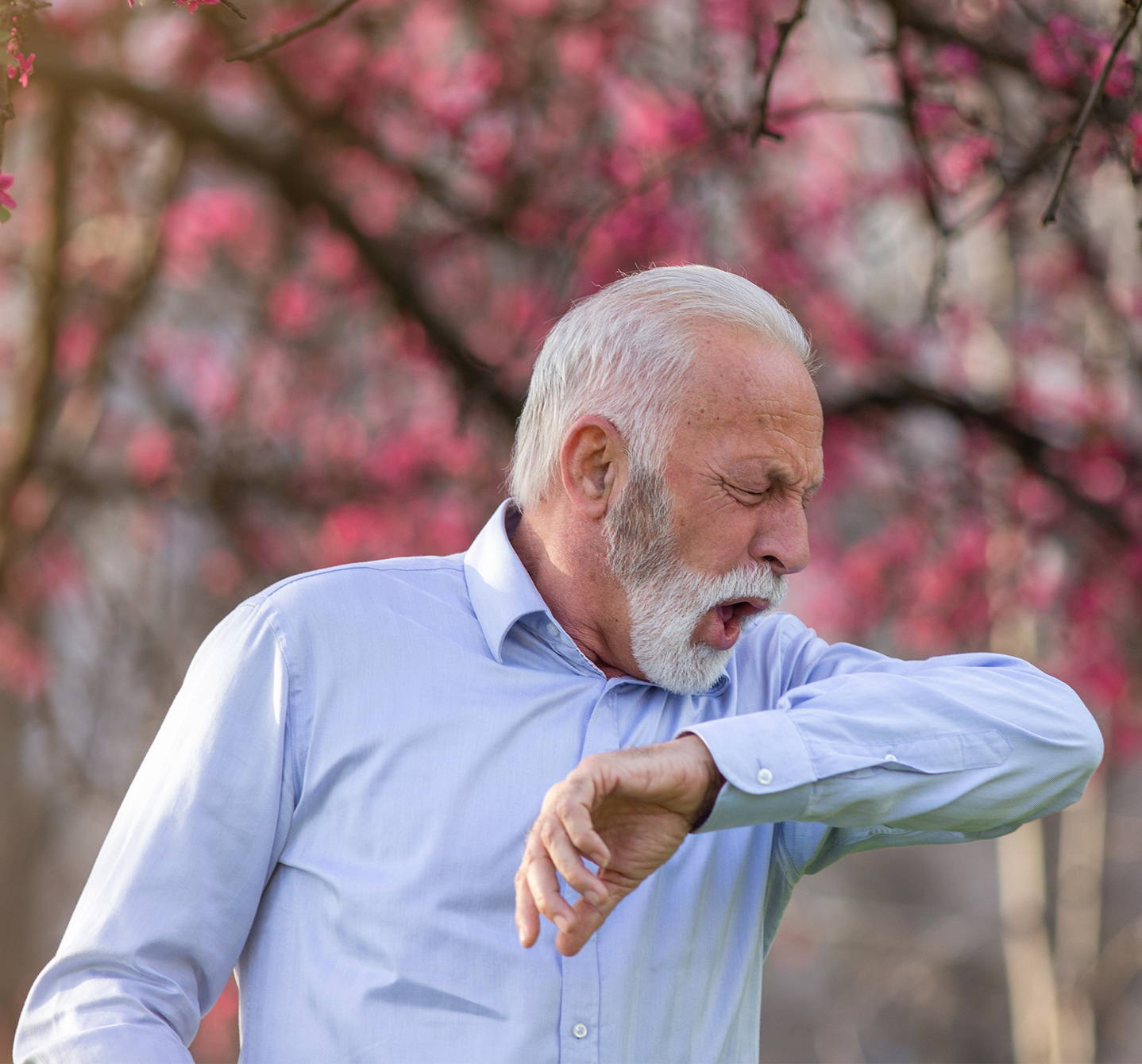 Allergy cough: Maybe this man coughing into his elbow in the park is having an allergic reaction to pollen