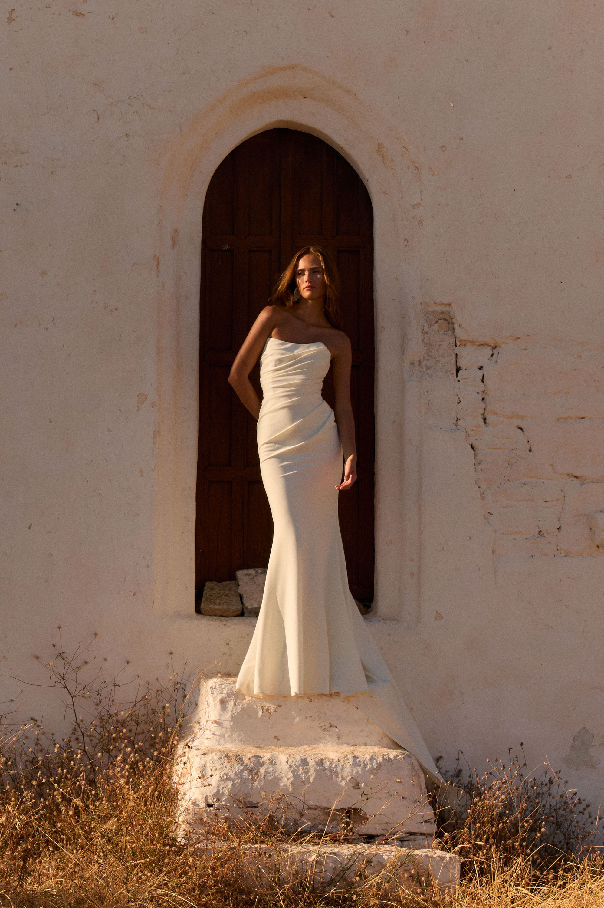 Model wearing a crepe strapless wedding dress