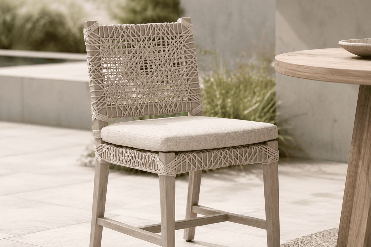 Woven outdoor dining chair with UV-resistant rope and upholstered performance cushion on a modern patio