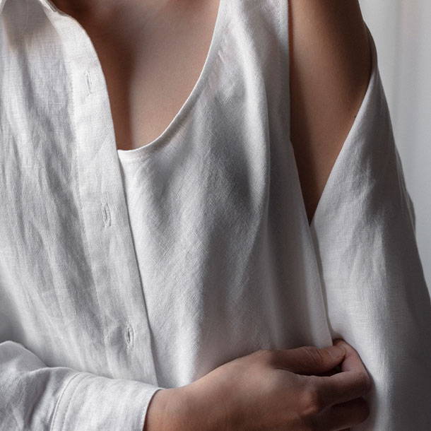 model wearing white linen shirt and singlet 