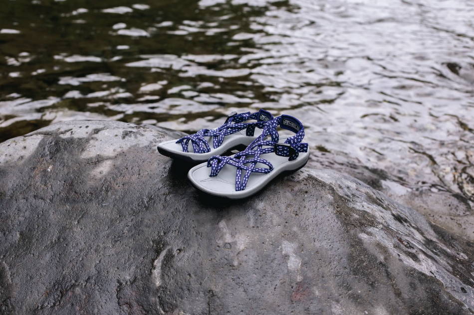 waterproof women's sandals next to a river